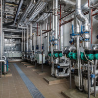 A complex network of pipes and valves for industrial water supply