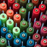 Array of textile thread spools in various colors
