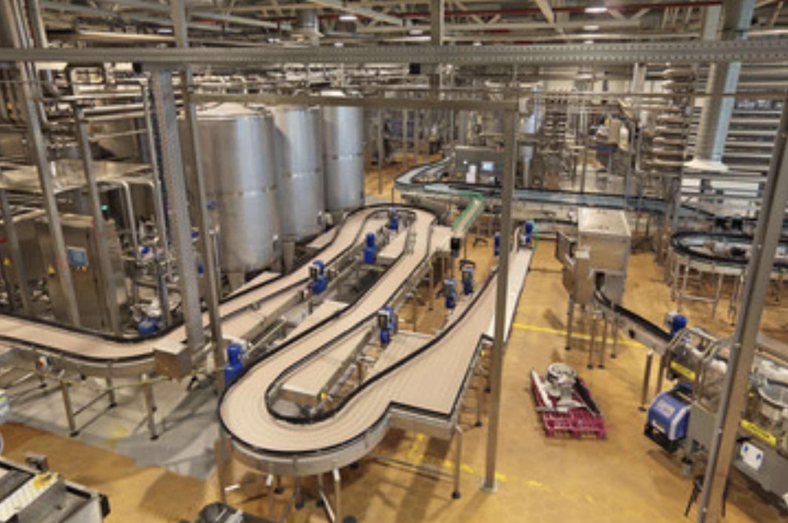 Industrial factory interior with conveyor belts and machinery